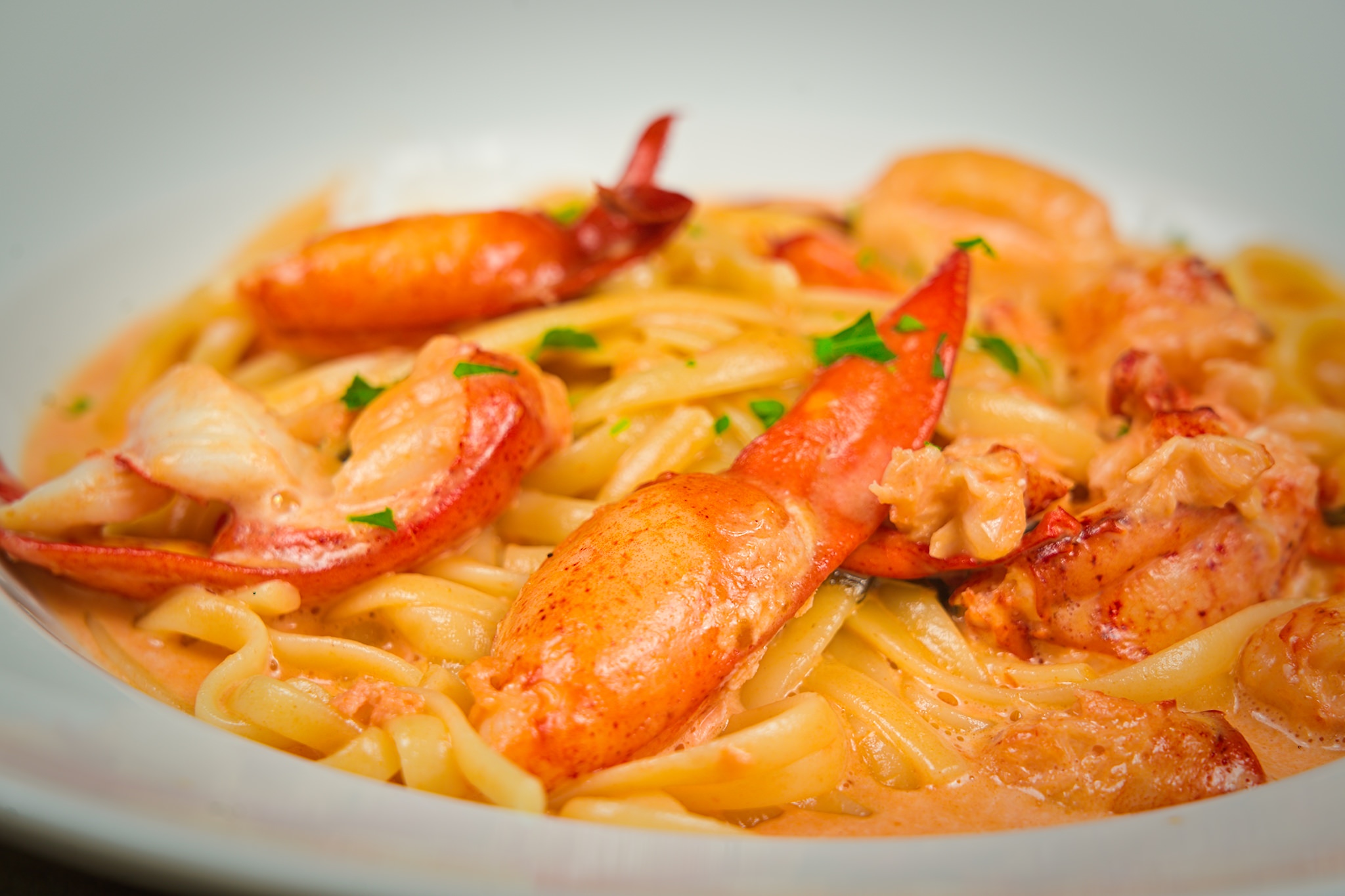 Linguini with lobster in a light tomato cream sauce.