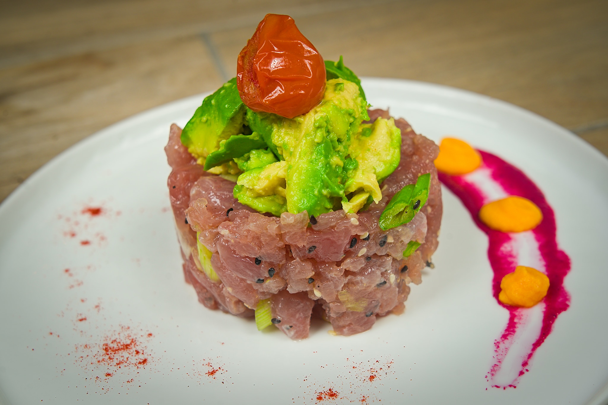 Diced Ahi Tuna and Capers, served on Garlic Mousse and topped with Avocado