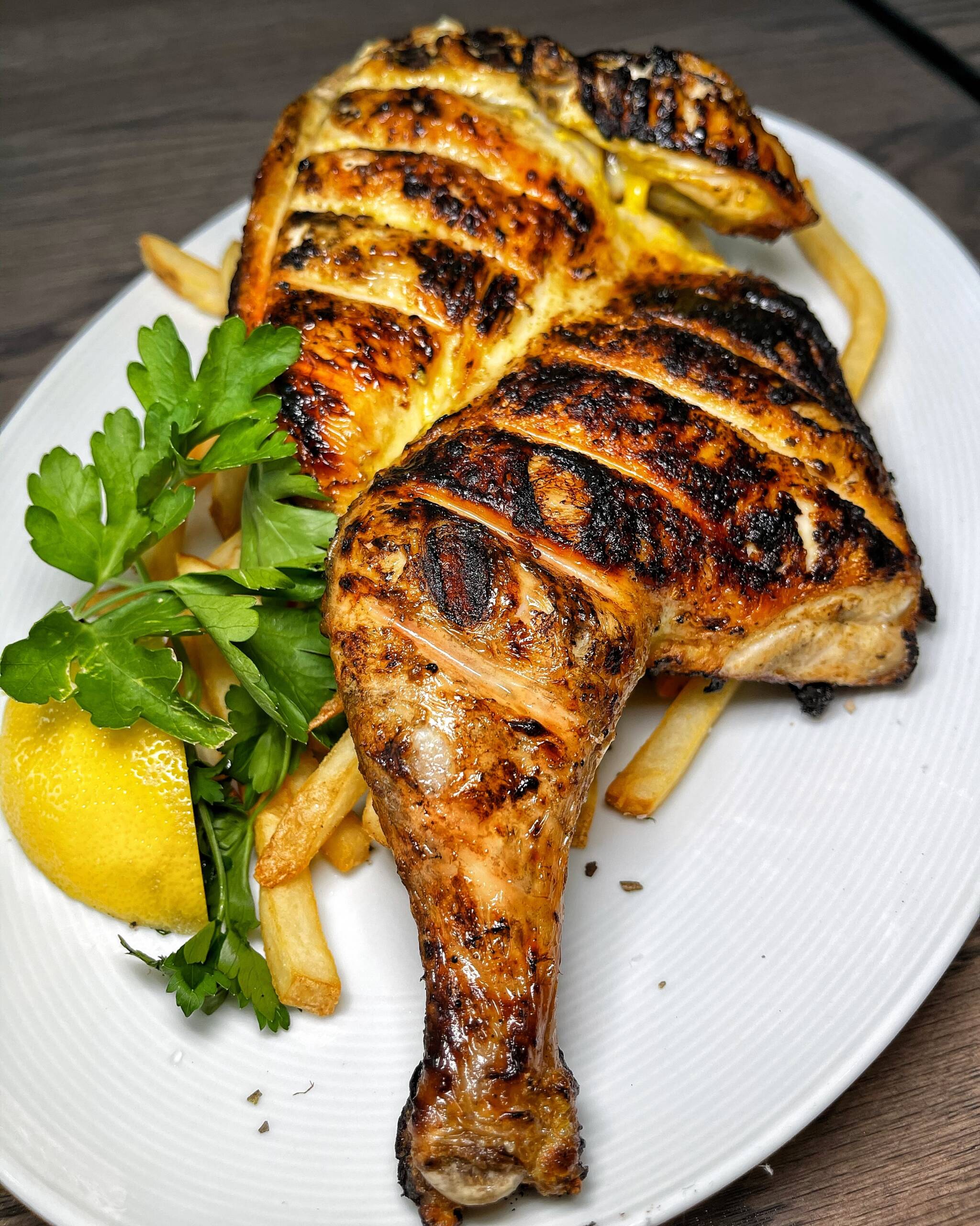 Char-broiled organic brick chicken served with hand cut fries