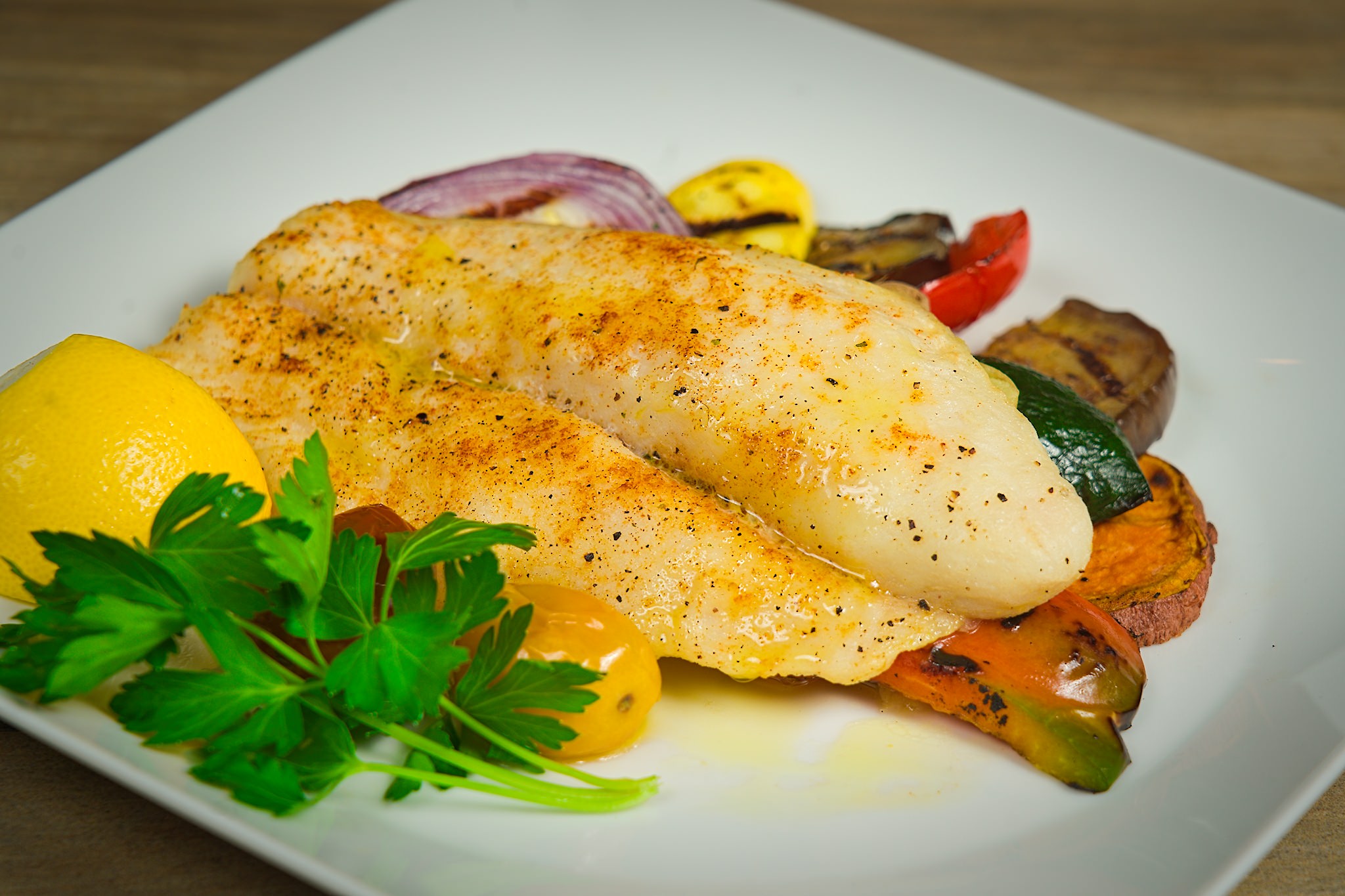Broiled fillet of Lemon Sole with bread crumbs over grilled vegetables