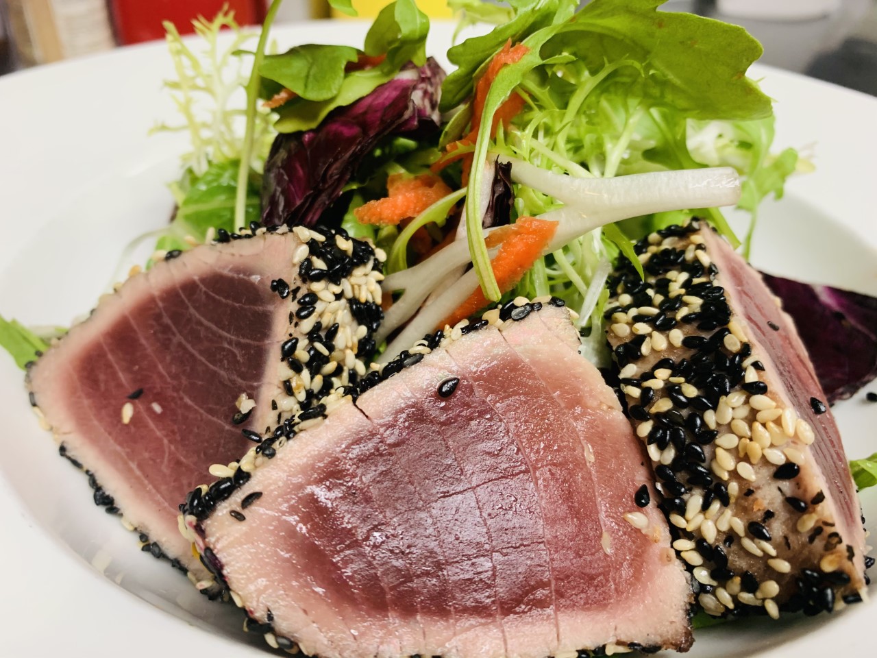 Sesame crusted tuna over farmers salad